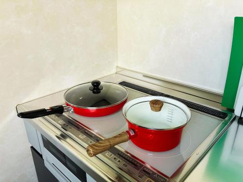 two pots and pans sitting on a stove in a refrigerator at Building A - Vacation STAY 72692v in Kikuchi