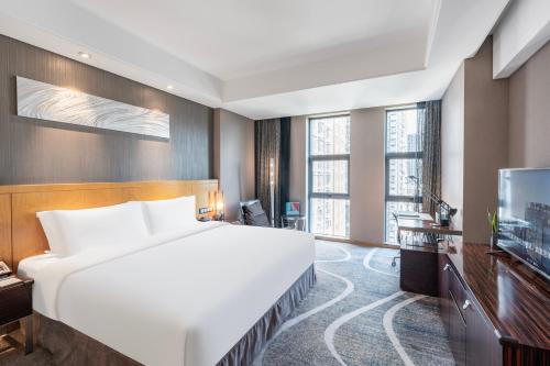 Postel nebo postele na pokoji v ubytování C Plaza Hotel