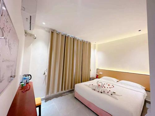 a hotel room with a bed and a window at Khamsay Hotel in Vientiane