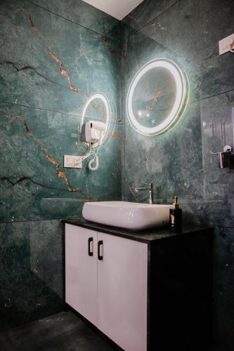 a bathroom with a sink and a mirror at Ethnic Villa Wayanad in Kenichira