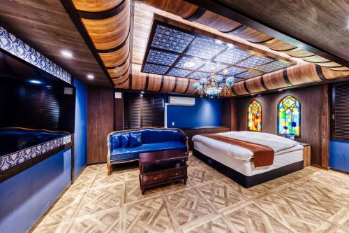 a bedroom with a bed and a stained glass window at Hotel Lotus Yokohama in Yokohama