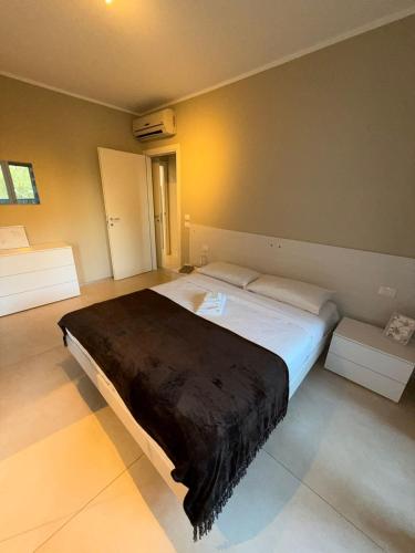 a bedroom with a large bed with a black blanket at Maggiore Panoramic Tower in Castel Maggiore