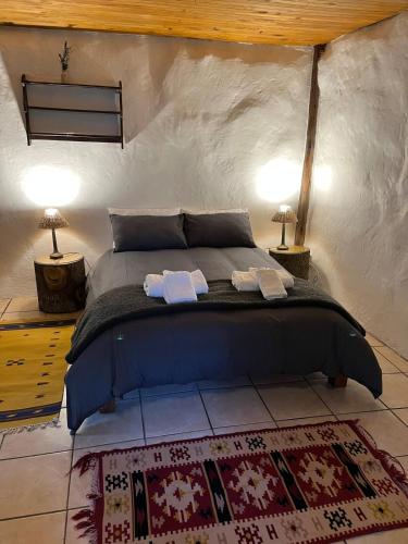 a bedroom with a bed with two towels on it at Enchanted Forest Cottage Escape! in Hogsback