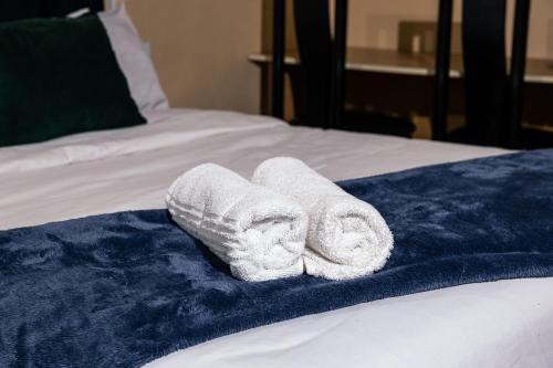 a pair of towels sitting on top of a bed at 166 Klipspringer Guest house in Germiston