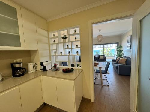 a kitchen and living room with a couch and a table at Brisa do Mar - 2BR Sea Front Luxury Apartment in Quarteira