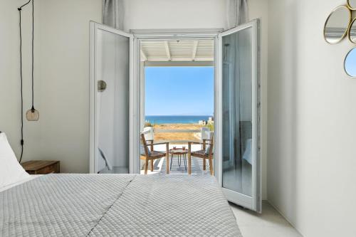 a bedroom with a bed and a view of the ocean at Selinofos in Naxos Chora