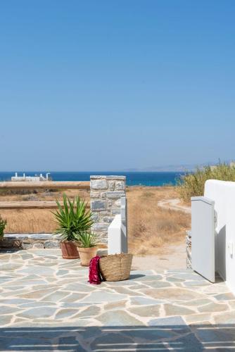 a stone patio with a view of the ocean at Selinofos in Kastraki