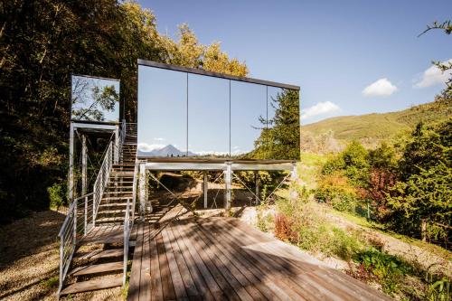a glass house on the side of a hill at Spino Fiorito Stay in Casola in Lunigiana