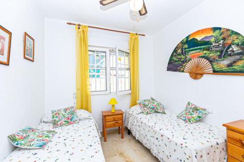 a bedroom with two beds and a window at Villa is located about 700 meters from the beach !!! in Ban Lamai