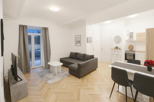 a living room with a couch and a table at Céleste Suites in Vienna