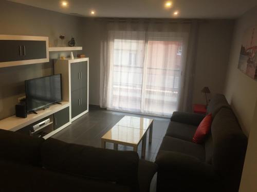 a living room with a couch and a table at Apartamento Turístico Obispo36 en Orihuela ciudad in Orihuela