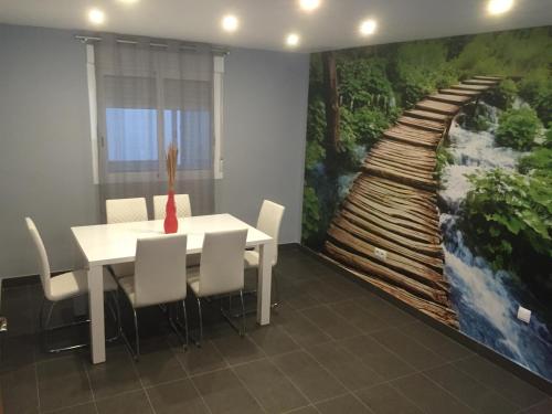 a dining room with a large painting on the wall at Apartamento De Lujo En Orihuela Ciudad in Orihuela