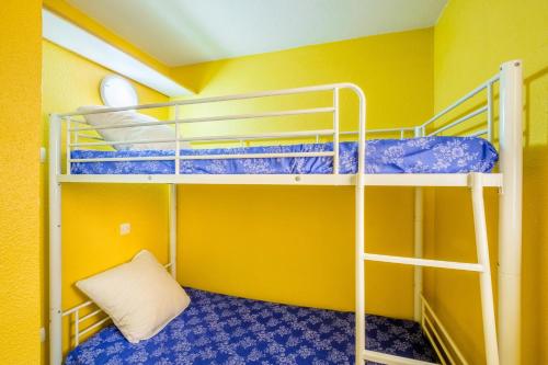 a bunk bed room with two bunk beds in a yellow room at Palme d'or in Cannes