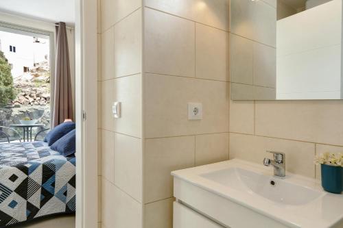 a small bathroom with a sink and a window at Albamar 1d in Puerto de Mogán