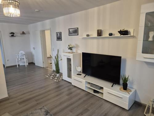 a living room with a large flat screen tv at Neu 4 Zi Kü Bad Coll-mar in Neunkirchen
