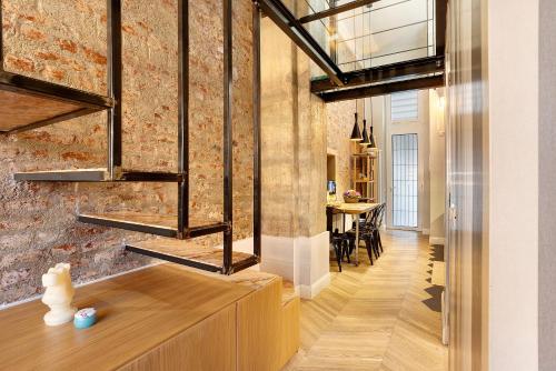 a room with a brick wall and a dining room at Dezza Loft in Milan