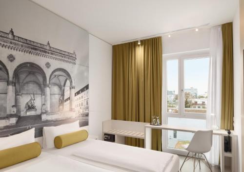 a bedroom with a bed and a desk and a window at Super 8 by Wyndham Munich City North in Munich