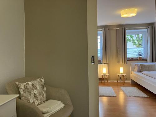 a living room with a couch and a bed and a window at Enz in Bietigheim-Bissingen