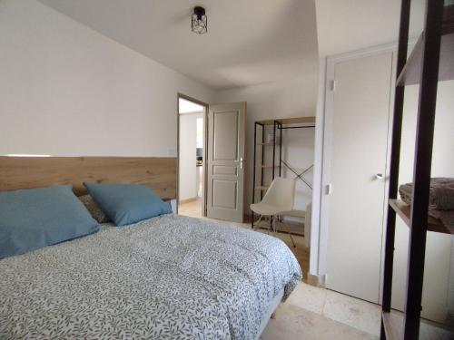 a bedroom with a bed and a chair in it at Mas Des Genêts in Laurac-en-Vivarais