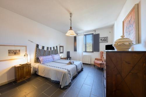 a bedroom with a bed and a chair in it at Villa Olivia Cielo e Terra in Merine