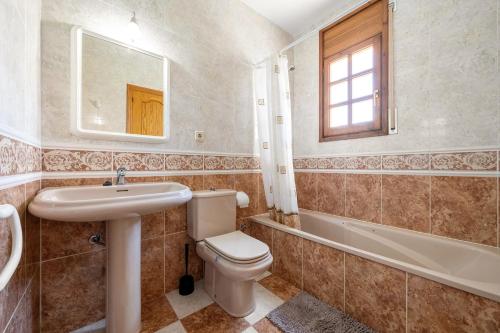 a bathroom with a toilet and a sink and a tub at Vila Tres Cales in Les tres Cales