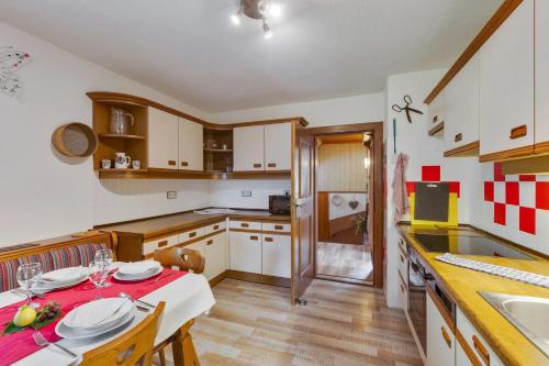 a kitchen with a table with a red table cloth on it at Naturoase in Wolfsberg