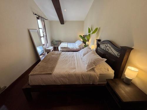 a bedroom with a large bed with two lights on at Cozy Loft & Terrace in Antigua in Antigua Guatemala