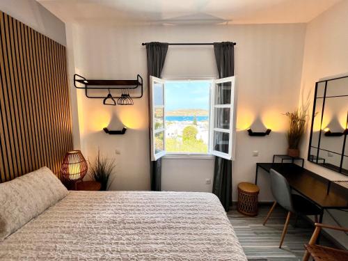a bedroom with a bed and a window at aeolian blu 9 in Parikia