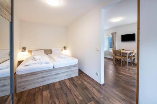 a bedroom with a bed and a dining room at Appartement Sophia in Sankt Martin