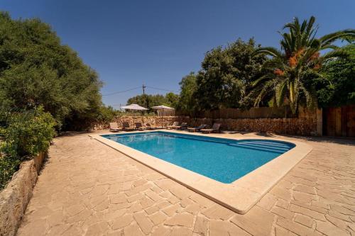 a swimming pool in a yard next to a fence at Cugulutx in Llucmajor