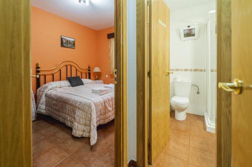 a bedroom with a bed and a toilet at Valle De Juarros in San Adrián de Juarros
