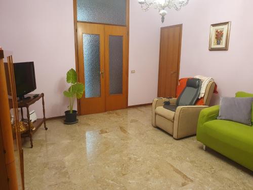 a living room with a couch and a chair and a tv at Casa Antonietta in Treviso