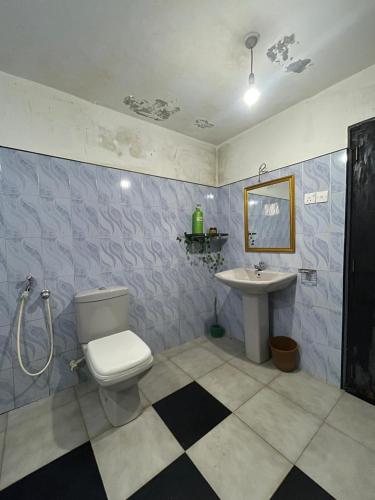 a bathroom with a toilet and a sink at Backpackers in Matara