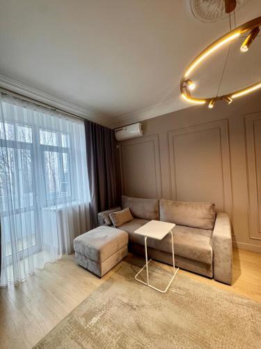 a living room with a couch and a table at Central Park Apart in Karagandy