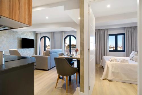 ein Hotelzimmer mit einem Bett und einem Esszimmer in der Unterkunft Apartamento Calle Larga 46 in Jerez de la Frontera