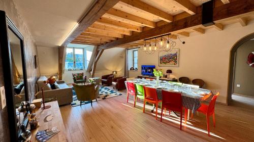 a living room with a dining room table and chairs at 2 - Seigneurie Fouquet - Chipagan in Le Palais