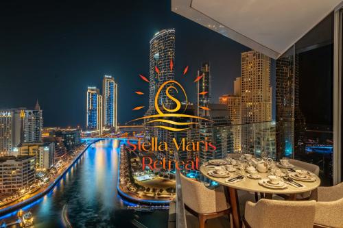 a view of a city skyline at night from a restaurant at Deluxe Marina View 2BR - Stella Maris Retreat in Dubai