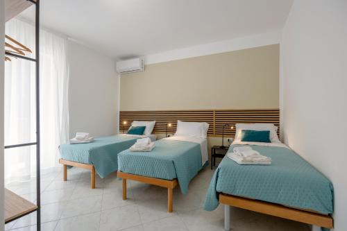 a hospital room with two beds and a mirror at Piazzetta al mare in Palermo