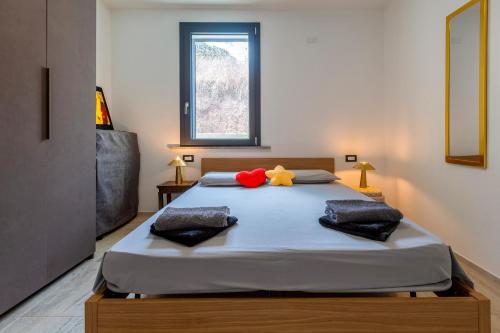 a bedroom with a bed with a stuffed animal on it at Villaggio Bellavista in Tergu