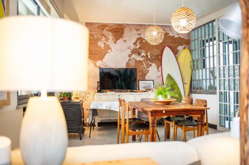 a dining room with a table and surfboards on the wall at B&B La Volpina in Rimini