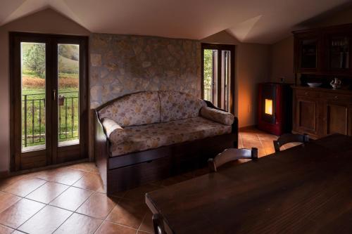 a living room with a couch and a balcony at Spina Lake Rooms Matese in San Gregorio