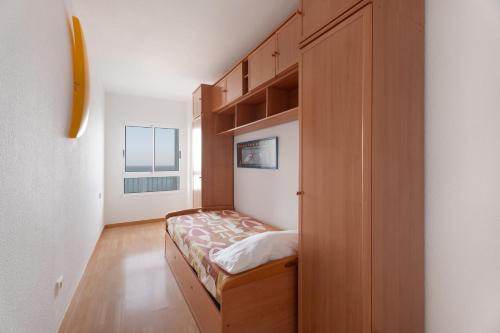 a bedroom with a bed in a wooden cabinet at Apto Bajamar Seaview in Bajamar