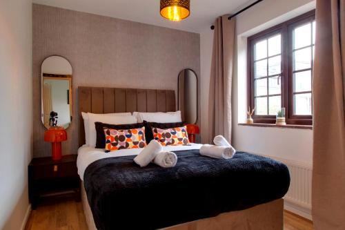 ein Schlafzimmer mit einem großen Bett mit Handtüchern darauf in der Unterkunft Stylish Victorian Terrace in Central Cambridge Pass the Keys in Cambridge