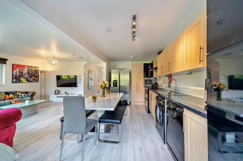a kitchen with a table and a dining room at La Fortuna Lodges in Stirling