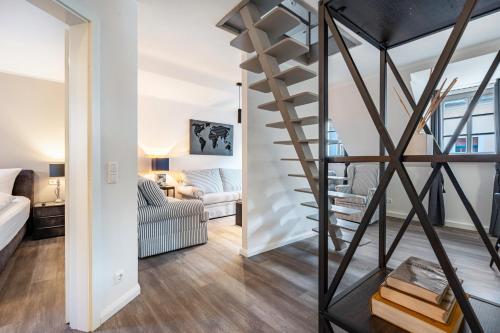 a spiral staircase in a living room with a couch at Quartier am weißen Gold in Meißen