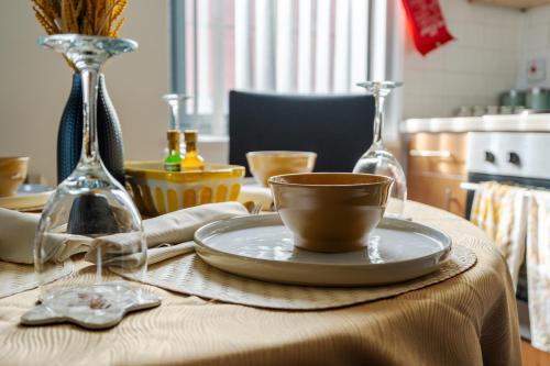 a table with a plate and a cup on it at Beehive Salford Quays immaculate 1-Bed Flat with free-parking in Manchester