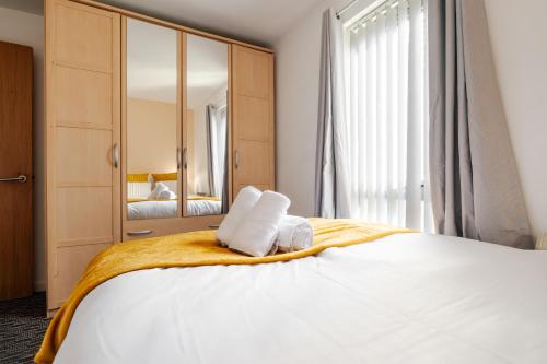 a bedroom with a large bed with two pillows on it at Beehive Salford Quays immaculate 1-Bed Flat with free-parking in Manchester
