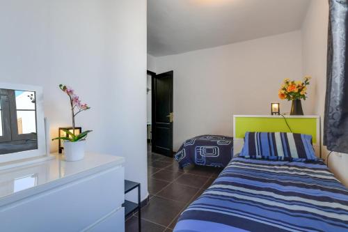 a bedroom with a bed and a window at Casa Conchita in Playa Honda