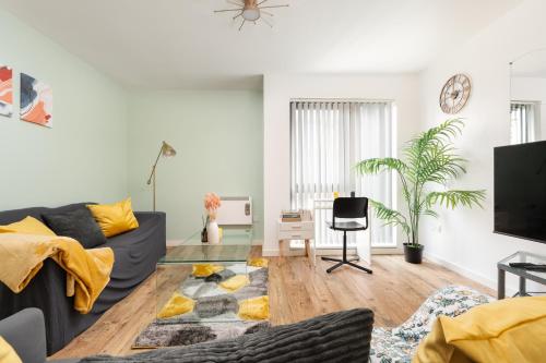 a living room with a couch and a table at Beehive Salford Quays immaculate 1-Bed Flat with free-parking in Manchester
