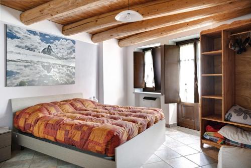 a bedroom with a large bed in a room at Stella Alpina Tano di Grich in Cesani